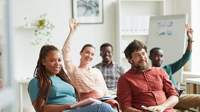 Professionals sat facing forward in a learning enviroment